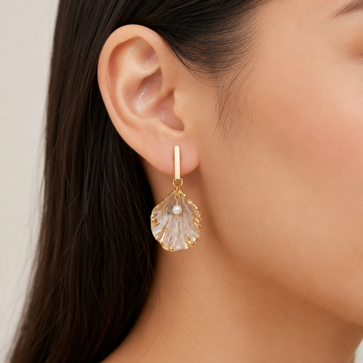 Gilded Seashell & Pearl Drop Earrings shown on ear